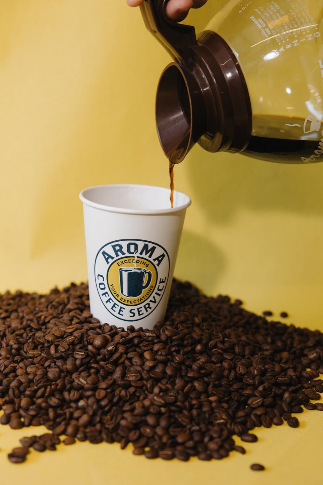 Branded cup coffee pour — Aroma Coffee Service