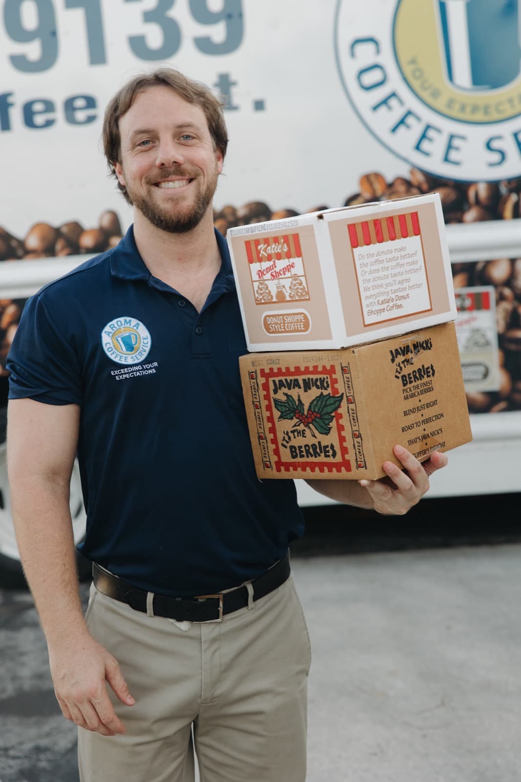 Employee holding coffee cases van — Aroma Coffee Service