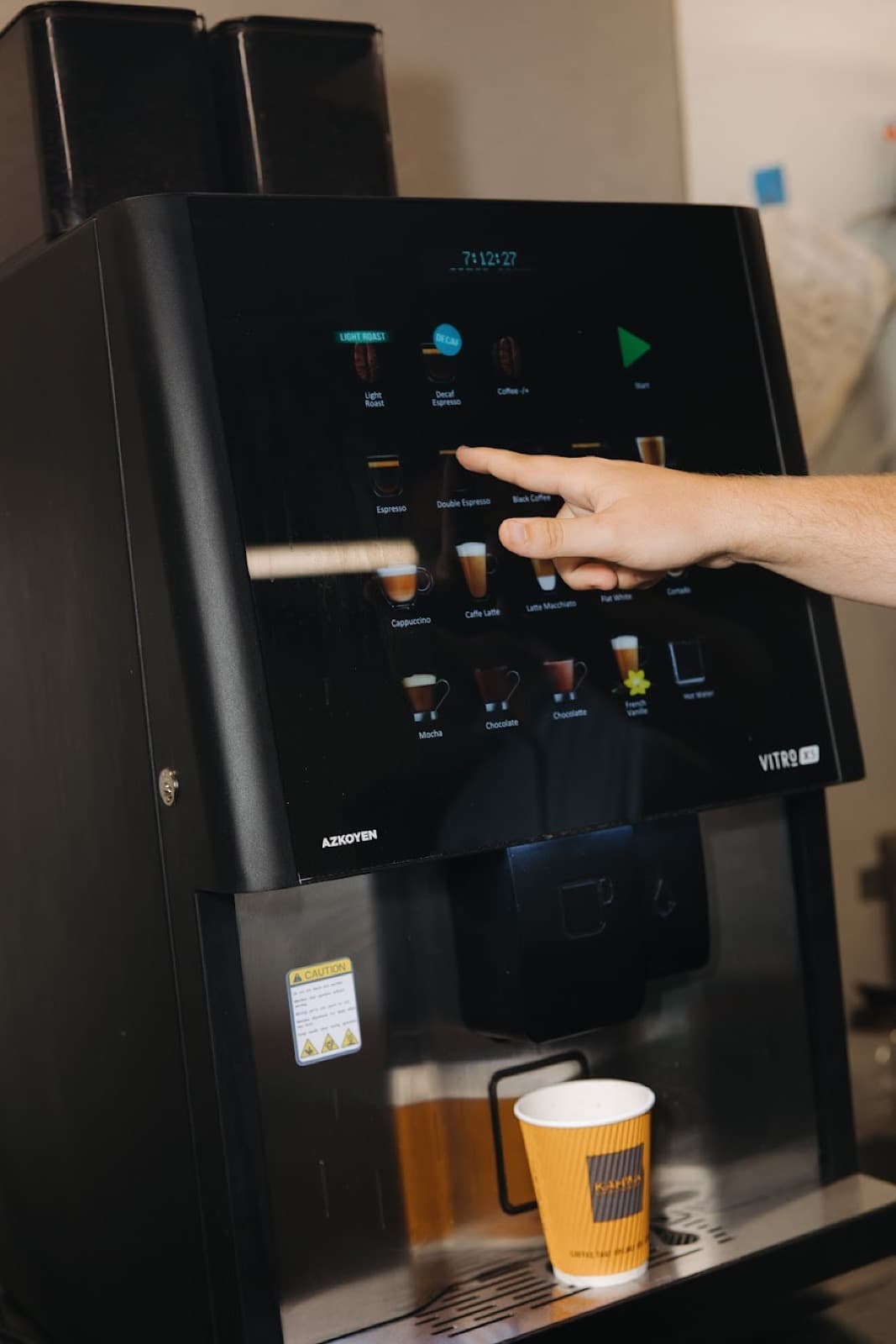 Hand selecting bean to cup touchscreen — Aroma Coffee Service